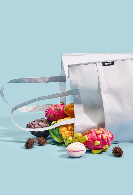Gray recycled eco friendly tote bag with fruit spilling out